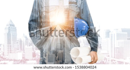 Engineer work with highway construction project. Double exposure image of professional man in engineer uniform holding helmet and engineering drawing against background of highway and city.