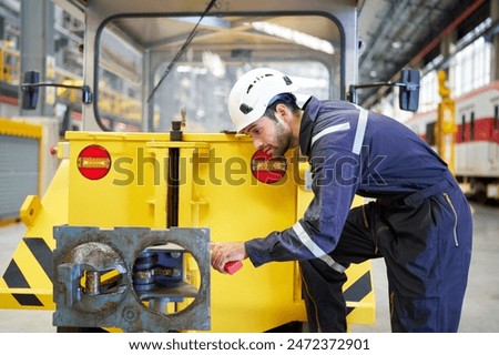Engineer or worker check before fixing a car in the factory