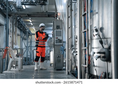 Engineer worker checking quality control of conveyor belt system at the canned food factory. Staff inspecting at manufacturing production line