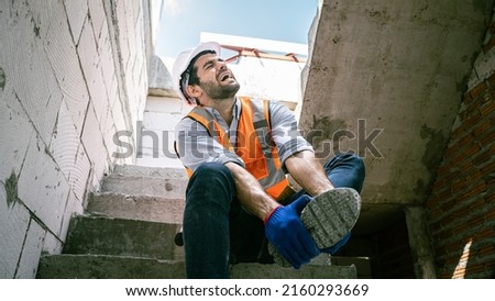 Engineer Worker Middle Eastern He was groaning,showing his feet injuredHandsome engineer injured his ankle when he stepped on a nail while inspecting a house project.Unsafe act,condition concept