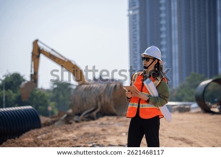 Engineer worker operations construction plans large black drainage pipe installing underground infrastructure heavy machinery importance of careful planning and teamwork in construction project.