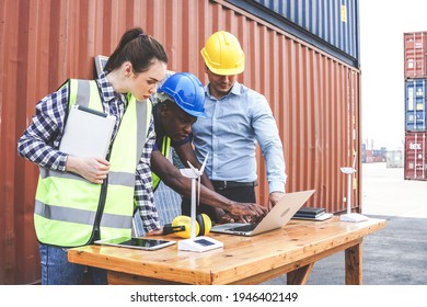 Engineer Worker Team Discussing Of Solar Energy From Wind Turbine Model And Laptop At Construction Site. Diversity People Brainstorming And Working Together