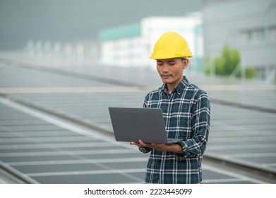 Engineer worker technology solar cell, Asian engineer working on roof top factory checking solar cell power system for project reduce usage electricity in factory 