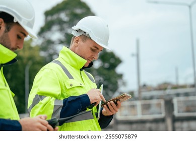 Engineer worker using mobile phone at construction site of petroleumchemical industry or refinery oil plant factory