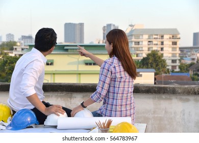 Engineer with Workers project planning and inspect  on building construction site