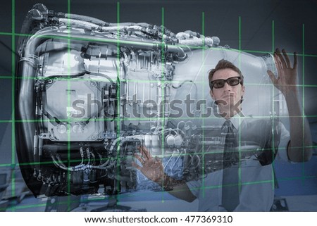 Engineer working with 3D display of Jet Engine, seen through interactive screen