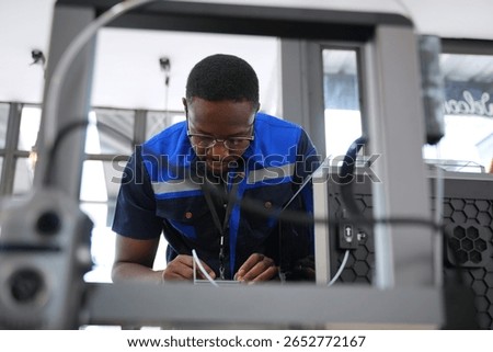 Engineer is working at 3D printing workshop. Engineering, technology.