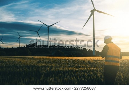 Engineer working at alternative renewable wind energy farm - Sustainable friendly industry concept