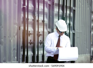 Engineer is working with blue print.