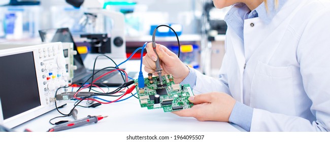 Engineer working with circuits. A woman engineer solders circuits sitting at a table. 
Microchip production factory. 
Girl repairing electronic device on the circuit board. - Shutterstock ID 1964095507