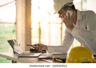 Engineer working with computer laptop about construction plan on site