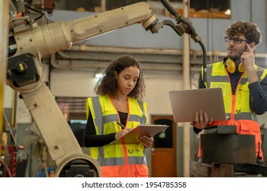 Engineer working and control robotic arm in manufacturing workshop,Industry and engineering technology concept.