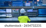 Engineer working at control room, Manager control system, Technician man monitoring program from a lot of monitor.Specialist observes analytics dashboard,operator inspects digital interface