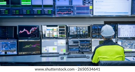Engineer working at control room, Manager control system, Technician man monitoring program from a lot of monitor.Specialist observes analytics dashboard,operator inspects digital interface