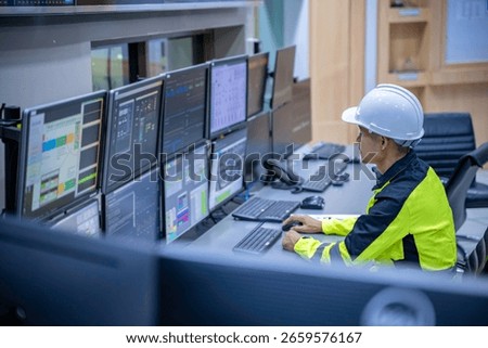 Engineer working at control room, Manager control system, Technician man monitoring program from a lot of monitor.Specialist observes analytics dashboard,operator inspects digital interface