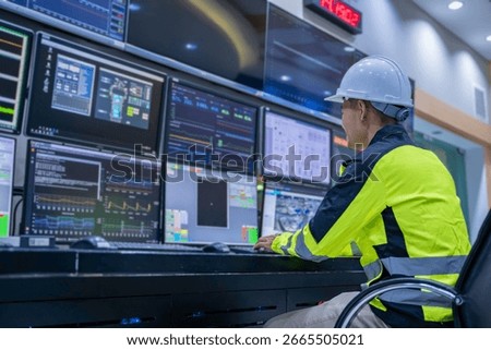 Engineer working at control room, Manager control system, Technician man monitoring program from a lot of monitor.Specialist observes analytics dashboard,operator inspects digital interface