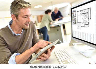 Engineer Working In Design Office On Desktop Computer