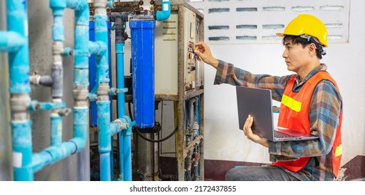 Engineer Working In Drinking Water Factory Using A Tablet Computer To Check Water Management System And Boiler Water Pipe In Water Factory