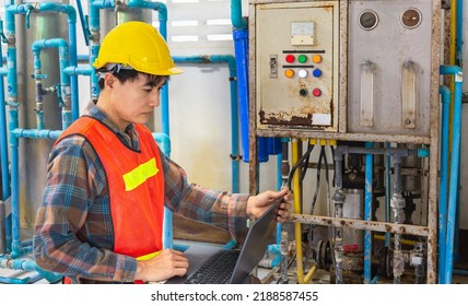 Engineer Working In Drinking Water Factory Using A Tablet Computer To Check Water Management System And Boiler Water Pipe In Water Factory