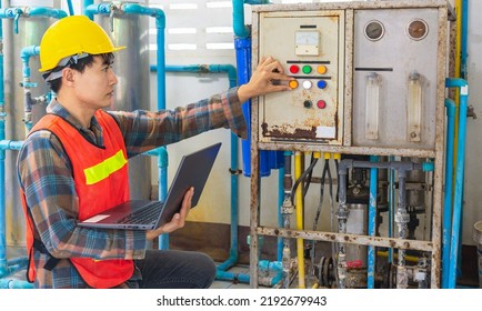 Engineer Working In Drinking Water Factory Using A Tablet Computer To Check Water Management System And Boiler Water Pipe In Water Factory