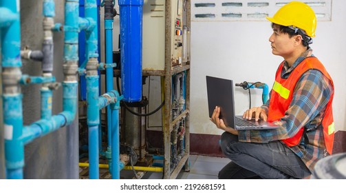 Engineer Working In Drinking Water Factory Using A Tablet Computer To Check Water Management System And Boiler Water Pipe In Water Factory