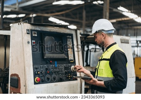 Engineer is working in the factory. Mechanical technicians are maintaining the engine.