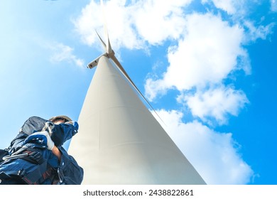 engineer working in fieldwork outdoor. Technicians of wind turbine checking and maintenance Electricity wind generator.. operation of wind turbines that converts wind energy into electrical energy