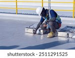 Engineer is working inspection damaged of roof slab of watertank finding concrete crack and damaged of water proofing above water tank