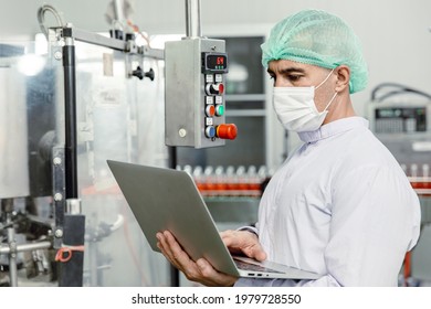 Engineer Working With Laptop In Food Factory Machine Production Inspector With Hygiene Clothes.