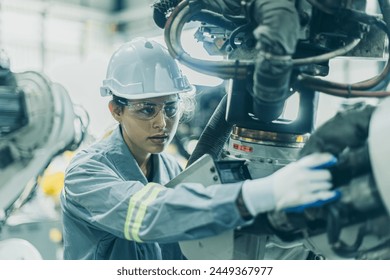 Engineer working machine assembly in advance technology robotic factory industry, Service maintenance robot arm cable part