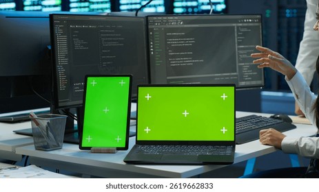 Engineer working with mockup laptop and tablet in data center used for managing gear energy consumption. Employee using green screen devices in workplace used for automation in server farm, camera A