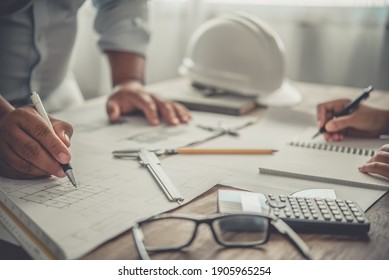 engineer working in office with blueprints, inspection in workplace for architectural plan, construction project ,Business construction	 - Powered by Shutterstock