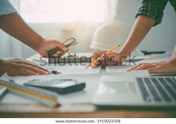 engineer working in office with\
blueprints, inspection in workplace for architectural plan,\
construction project ,Business\
construction	