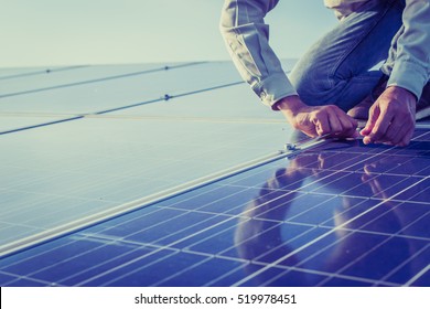 engineer working on checking and maintenance equipment at solar power plant: working on Wrench tightening solar mounting structure of solar panel  - Shutterstock ID 519978451