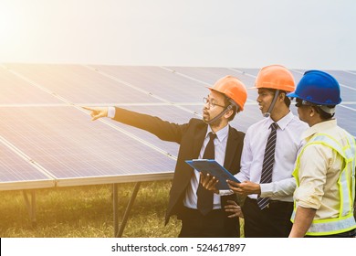 engineer working on checking and maintenance equipment at industry solar power; three engineer discussion plan to find problem of solar panel