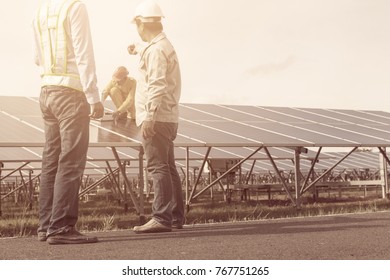 engineer working on checking and maintenance electrical equipment ; engineer inspector working on examining electrical system of solar power plant 
