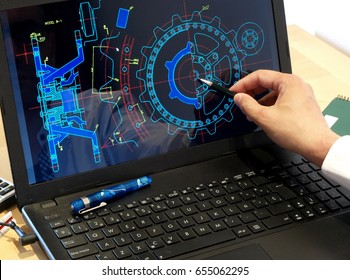 Engineer Working On Computer At The Design Of Mechanical Piece  