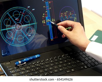 Engineer Working On Computer On Mechanical Piece Design  