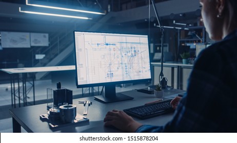 Engineer Working on Desktop Computer, Screen Showing CAD Software with Technological Blueprints. Industrial Design Engineering Facility. Over the Shoulder Shot