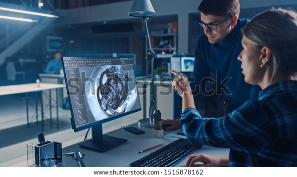 Engineer\
Working on Desktop Computer, Screen Showing CAD Software with\
Engine 3D Model, Her Male Project Manager Explains Job Specifics.\
Industrial Design Engineering Facility\
Office