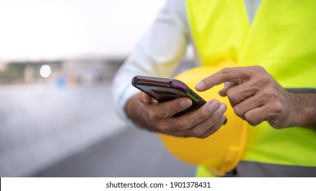 Engineer Working On His Smart Phone At The Construction Site