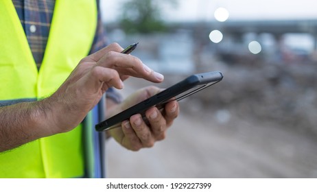engineer working on his smartphone at the construction site