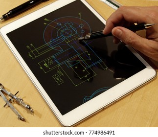 Engineer Working On Mechanical Piece Design Blueprint Using A Tablet Computer       