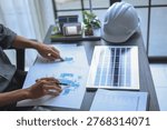 Engineer Working on Solar Panel Design and System Planning on Desk.