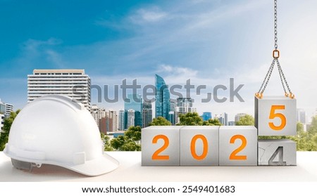 engineer working table and construction-crane are lifting year 2025 in concrete cube replace the passed year 2024. new year party and change new business for modern city and environment friendly.