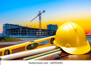 Engineer Working Table Plan And Blueprint At Building Construction Site Against Beautiful Sky Sunset