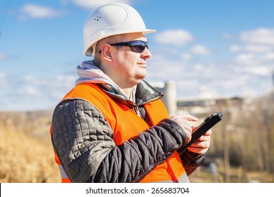 Engineer working with tablet PC at outdoors
