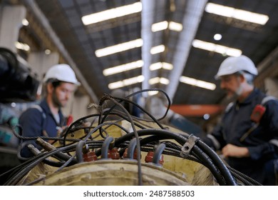Engineer is working at train machine part factory. Blue collar worker and heavy industry.