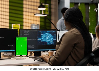 Engineer writing code on green screen tablet, developing machine learning APIs. Admin using chroma key device to troubleshoot software errors using artificial intelligence