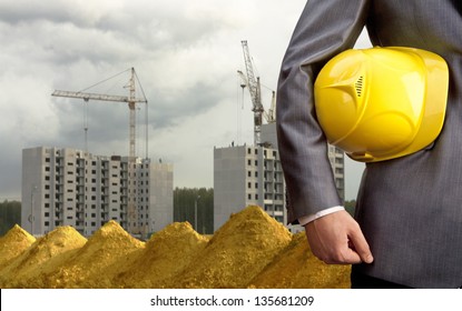 engineer yellow helmet for workers security over new houses and crane background